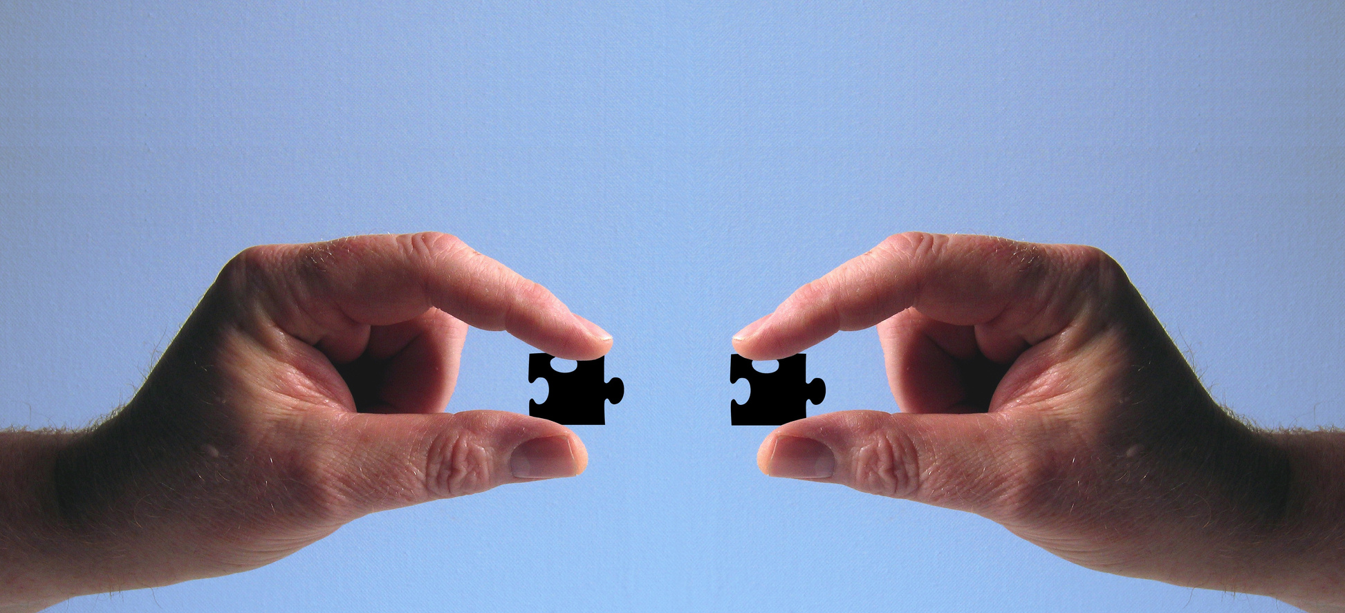 Hands Holding Jigsaw Puzzles